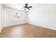 Bright bedroom with wood-look flooring and a window overlooking the neighborhood at 8334 E Palm Ln, Scottsdale, AZ 85257