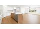 Modern kitchen with white cabinets, stainless steel appliances, island, and wood-look flooring at 8334 E Palm Ln, Scottsdale, AZ 85257