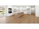 Modern kitchen featuring stainless steel appliances, a center island, and sleek white cabinetry at 8334 E Palm Ln, Scottsdale, AZ 85257