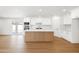 Bright kitchen with stainless steel appliances, a modern island, and hardwood floors at 8334 E Palm Ln, Scottsdale, AZ 85257
