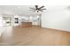 Open-concept living space featuring wood-look floors and white kitchen with stainless steel appliances at 8334 E Palm Ln, Scottsdale, AZ 85257