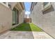 Low-maintenance backyard with stone patio and artificial grass at 8343 E Irwin Ave, Mesa, AZ 85209