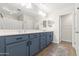 Bathroom with blue cabinets, double sinks, large mirror, and white countertops at 8343 E Irwin Ave, Mesa, AZ 85209