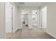 Hallway with carpet and neutral walls leading to bright rooms and doorways at 8343 E Irwin Ave, Mesa, AZ 85209