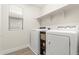 Laundry room featuring a modern washer and dryer, with extra storage shelves at 8343 E Irwin Ave, Mesa, AZ 85209
