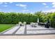 Spacious backyard with a dining area, lush landscaping, and a well-manicured lawn perfect for outdoor entertaining at 8425 E Bonnie Rose Ave, Scottsdale, AZ 85250