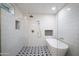 Bright bathroom featuring a soaking tub, stylish star patterned floor, and white subway tile at 8425 E Bonnie Rose Ave, Scottsdale, AZ 85250