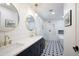 Stylish bathroom features double sinks, a soaking tub, and a glass-enclosed shower with decorative tile flooring at 8425 E Bonnie Rose Ave, Scottsdale, AZ 85250