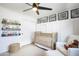 Charming Bedroom with crib, comfortable seating, and playful decor perfect for a cozy and welcoming space at 8425 E Bonnie Rose Ave, Scottsdale, AZ 85250