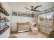 Cozy Bedroom with crib, chair, and wallpaper, creating a warm and inviting space for a baby at 8425 E Bonnie Rose Ave, Scottsdale, AZ 85250