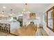 Bright, modern kitchen with stainless steel appliances, white cabinets, and a wooden dining table at 8425 E Bonnie Rose Ave, Scottsdale, AZ 85250