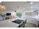 Stylish kitchen featuring a large island, stainless steel appliances, and an open view of the living room at 8425 E Bonnie Rose Ave, Scottsdale, AZ 85250