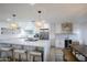 Bright kitchen with a large white island, stainless steel appliances, and modern pendant lighting at 8425 E Bonnie Rose Ave, Scottsdale, AZ 85250