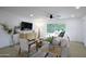 Bright living room with modern furnishings including a ceiling fan and a sliding glass door providing backyard views at 8425 E Bonnie Rose Ave, Scottsdale, AZ 85250