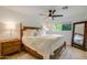 Inviting bedroom featuring a ceiling fan, wood furniture, and a window with natural light at 8425 E Bonnie Rose Ave, Scottsdale, AZ 85250