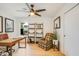 Bright home office with modern desk, comfortable chair, ceiling fan, and natural light streaming through the window at 8425 E Bonnie Rose Ave, Scottsdale, AZ 85250