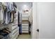 Organized walk-in closet featuring custom shelving, drawers, and ample storage space for clothing and accessories at 8425 E Bonnie Rose Ave, Scottsdale, AZ 85250