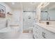 Luxurious bathroom featuring a soaking tub, walk-in shower, double vanity, and modern finishes at 8455 E Orange Blossom Ln, Scottsdale, AZ 85250