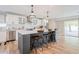 Modern kitchen featuring stainless steel appliances, a large island, and sliding glass doors to the outdoor area at 8455 E Orange Blossom Ln, Scottsdale, AZ 85250