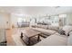 Spacious living area with open layout, hardwood floors, dining area, and kitchen island with modern appliances at 8455 E Orange Blossom Ln, Scottsdale, AZ 85250