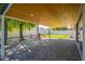 Relaxing outdoor patio area with pavers, a covered ceiling, and views of the lush backyard at 8455 E Orange Blossom Ln, Scottsdale, AZ 85250