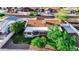 Aerial view of a home with a well-manicured lawn, mature trees, and a covered patio for outdoor enjoyment at 919 W Lodge Dr, Tempe, AZ 85283