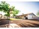 Expansive backyard features lush lawn, mature tree, and covered patio at 919 W Lodge Dr, Tempe, AZ 85283