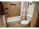 Bathroom with a shower-tub, neutral tiling, decorative shower curtain, and ample natural light at 919 W Lodge Dr, Tempe, AZ 85283