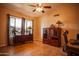 Cozy bedroom showcasing tile flooring, a ceiling fan, and ample natural light from a large window at 919 W Lodge Dr, Tempe, AZ 85283
