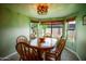 Dining area with a wooden table, chairs, and natural light from the surrounding windows at 919 W Lodge Dr, Tempe, AZ 85283
