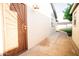 An outdoor perspective of a walkway that includes a metal gate and a white painted brick wall at 919 W Lodge Dr, Tempe, AZ 85283