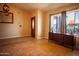 Inviting foyer with neutral walls, tile flooring, a console table, and a wooden front door at 919 W Lodge Dr, Tempe, AZ 85283