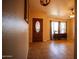 Welcoming foyer featuring a wooden front door, tile flooring, and a decorative console table at 919 W Lodge Dr, Tempe, AZ 85283