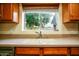 Kitchen sink area with a bright window view and neutral counter tops at 919 W Lodge Dr, Tempe, AZ 85283