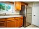 Kitchen area showcasing stainless steel refrigerator, ample cabinet space, and bright window at 919 W Lodge Dr, Tempe, AZ 85283