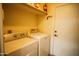 Laundry room features washer, dryer and storage shelf at 919 W Lodge Dr, Tempe, AZ 85283