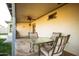 Charming covered patio featuring a glass-topped table with cushioned chairs and access to the backyard at 919 W Lodge Dr, Tempe, AZ 85283