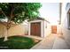 A backyard with lush lawn and a shed perfect for extra storage or hobbies at 919 W Lodge Dr, Tempe, AZ 85283