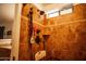 Shower features tile, rain shower head, traditional shower head, seat and built in niche at 919 W Lodge Dr, Tempe, AZ 85283