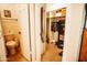 Toilet adjacent to walk-in closet with shelving and hanging storage plus gun safe at 919 W Lodge Dr, Tempe, AZ 85283