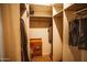 Walk-in closet features shelving for clothing and storage with hanging rack at 919 W Lodge Dr, Tempe, AZ 85283