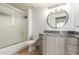 Clean bathroom featuring a shower and tub combination, granite counters, and modern vanity lighting at 9820 N Central Ave # 224, Phoenix, AZ 85020