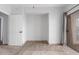 A cozy bedroom featuring neutral carpeting, an alcove, and access to the patio at 9820 N Central Ave # 224, Phoenix, AZ 85020