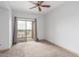 Sun-filled bedroom with a ceiling fan and balcony access at 9820 N Central Ave # 224, Phoenix, AZ 85020