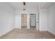 This bedroom features neutral carpeting, a closet with shelving, and an ensuite bathroom for added privacy at 9820 N Central Ave # 224, Phoenix, AZ 85020