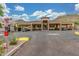 Community entrance with covered parking, mountains in the background, and desert landscape at 9820 N Central Ave # 224, Phoenix, AZ 85020