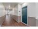 Well-lit hallway with wood flooring and neutral walls leading to various units within the building at 9820 N Central Ave # 224, Phoenix, AZ 85020