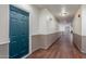 Clean hallway with wood floors and painted walls, leading to various units in a modern community at 9820 N Central Ave # 224, Phoenix, AZ 85020