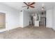 Open living space with neutral walls, ceiling fan, and access to the kitchen at 9820 N Central Ave # 224, Phoenix, AZ 85020