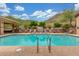 Community pool with lounge chairs, manicured landscape, and mountain views at 9820 N Central Ave # 224, Phoenix, AZ 85020
